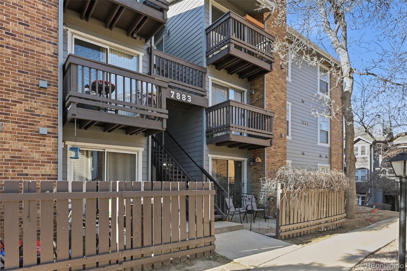 7883 Allison Way, Unit 302 Arvada, CO 80005 - Photo 3 of 29 a front view of a house with iron fence
