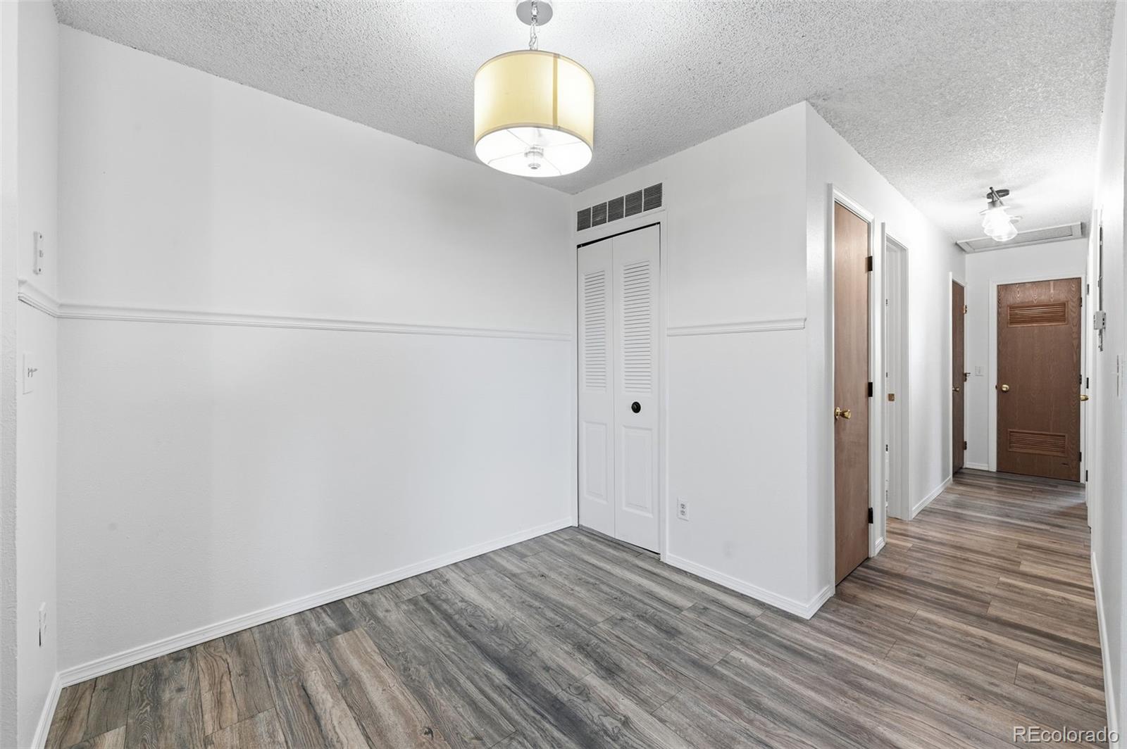 7883 Allison Way, Unit 302 Arvada, CO 80005 - Photo 10 of 29 a view of a room with wooden floor
