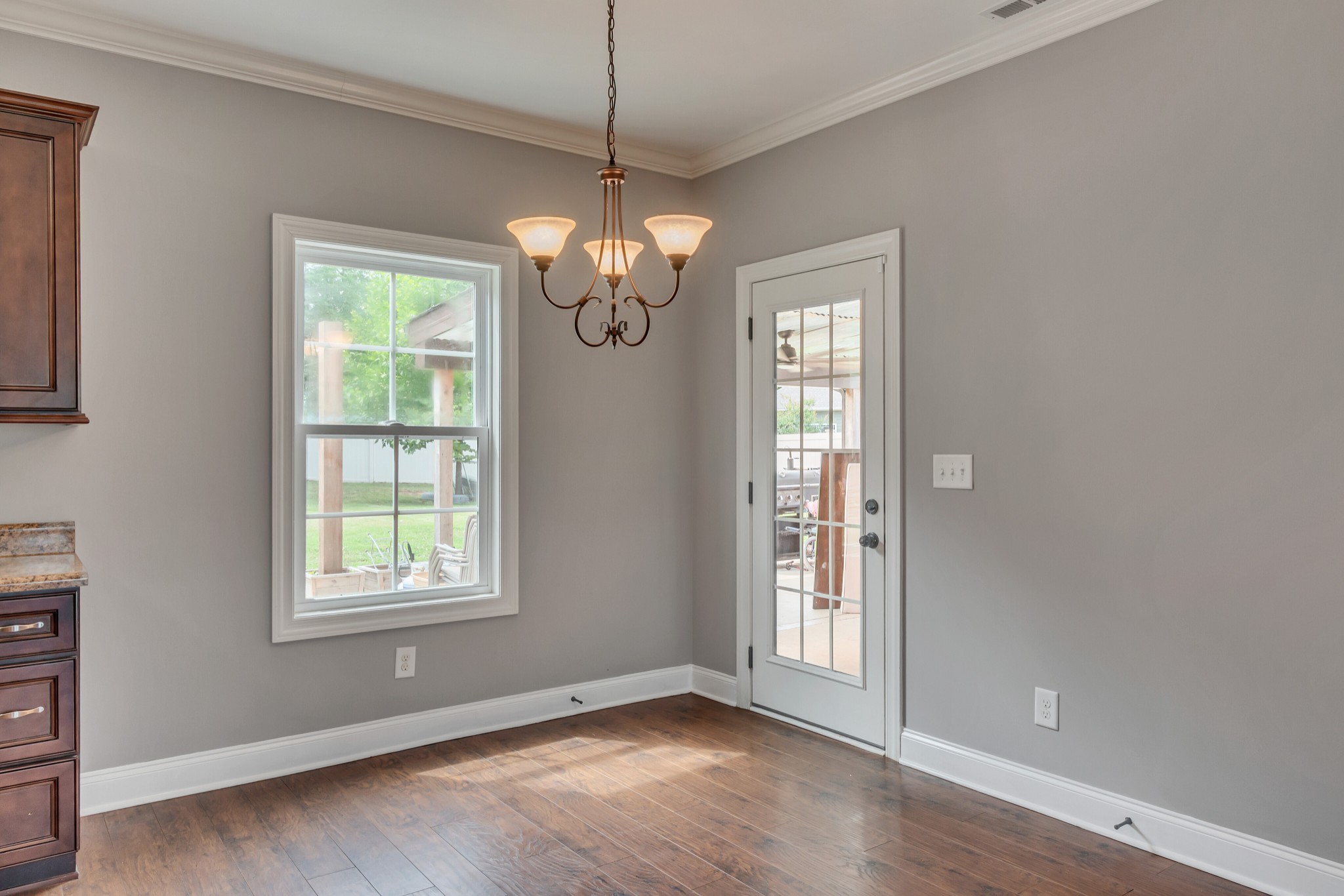 313 Drema Court Murfreesboro, TN 37127 - Photo 11 of 39 an empty room with wooden floor chandelier and windows