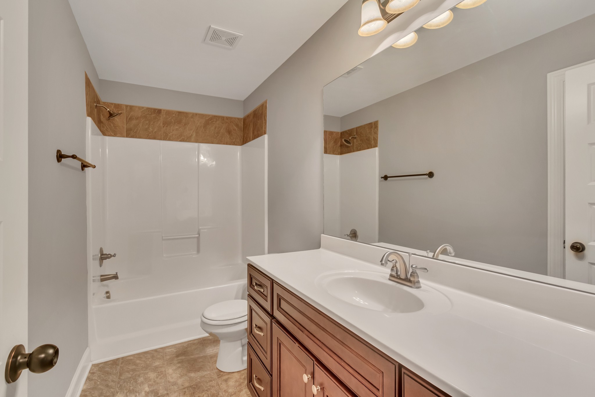 313 Drema Court Murfreesboro, TN 37127 - Photo 25 of 39 a bathroom with a sink a toilet a mirror a bathtub and shower