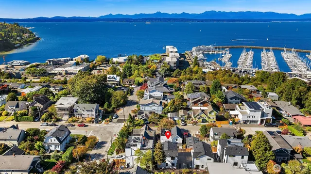 an aerial view of a house with a yard
