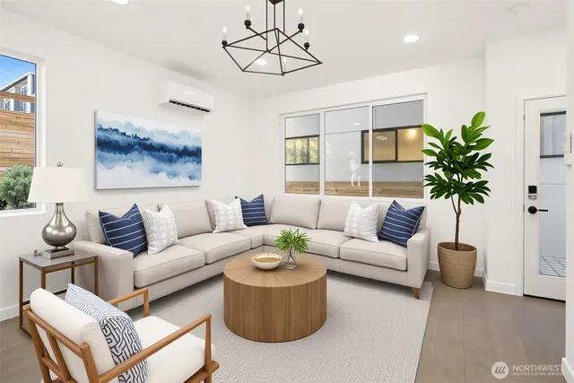 a living room with furniture a chandelier and a potted plant