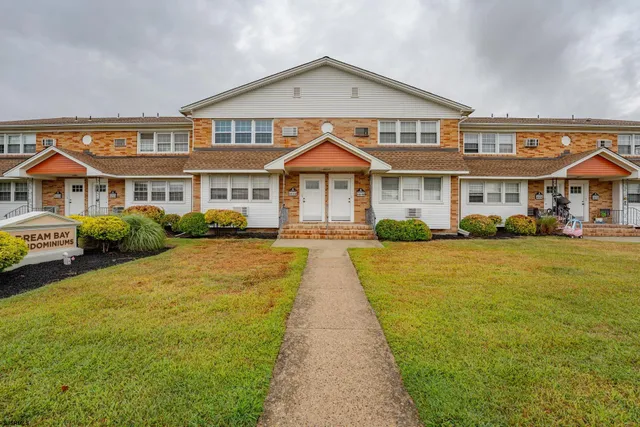 a front view of a house with a yard table and chairs