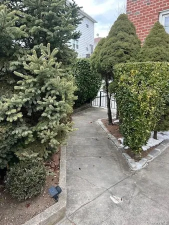 a view of a pathway both side of the yard