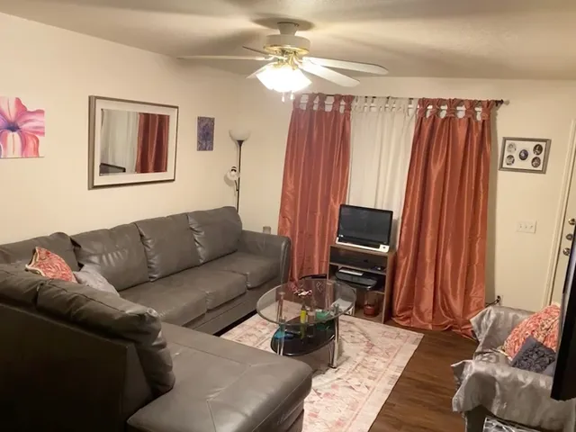 a living room with furniture and a flat screen tv