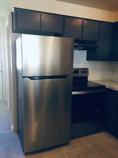 a refrigerator freezer sitting inside of a kitchen