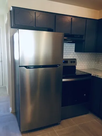 a refrigerator freezer sitting inside of a kitchen