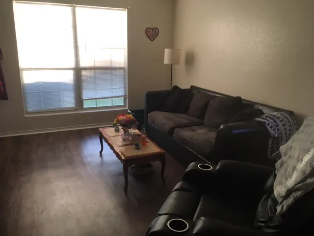 a living room with furniture and a window
