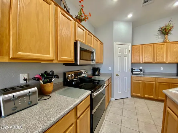 a kitchen with a sink a stove and cabinets