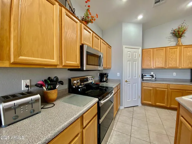 a kitchen with a sink a stove and cabinets