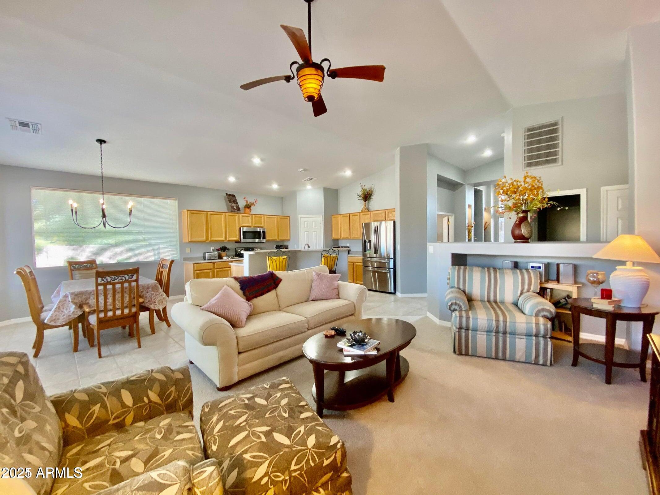 8320 East Masters Road Gold Canyon, AZ 85118 - Photo 5 of 5 a living room with furniture kitchen view and a chandelier