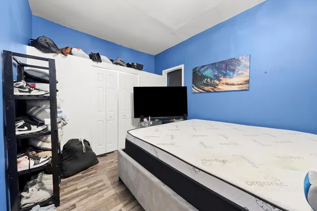 a bedroom with a bed and a flat screen tv