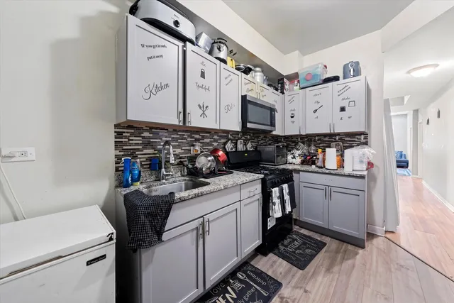 a kitchen with sink cabinets and stove