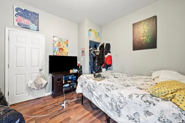 a bedroom with a bed and a flat screen tv