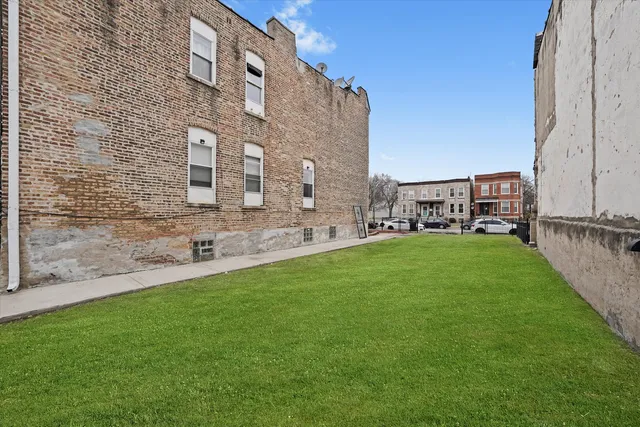 a view of a building with a yard