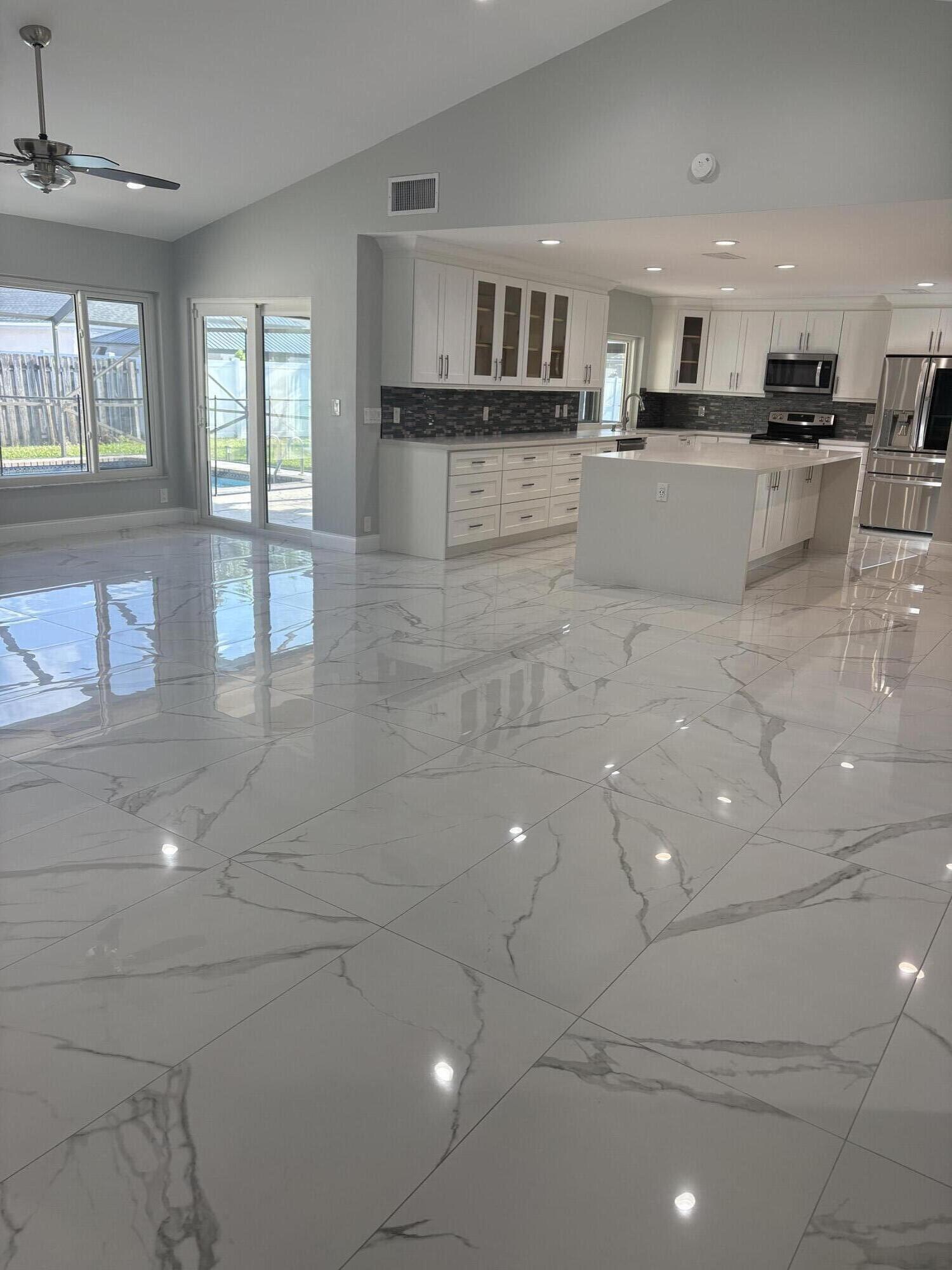 18255 181st Circle South Boca Raton, FL 33498 - Photo 15 of 16 a kitchen with stainless steel appliances a sink and a refrigerator