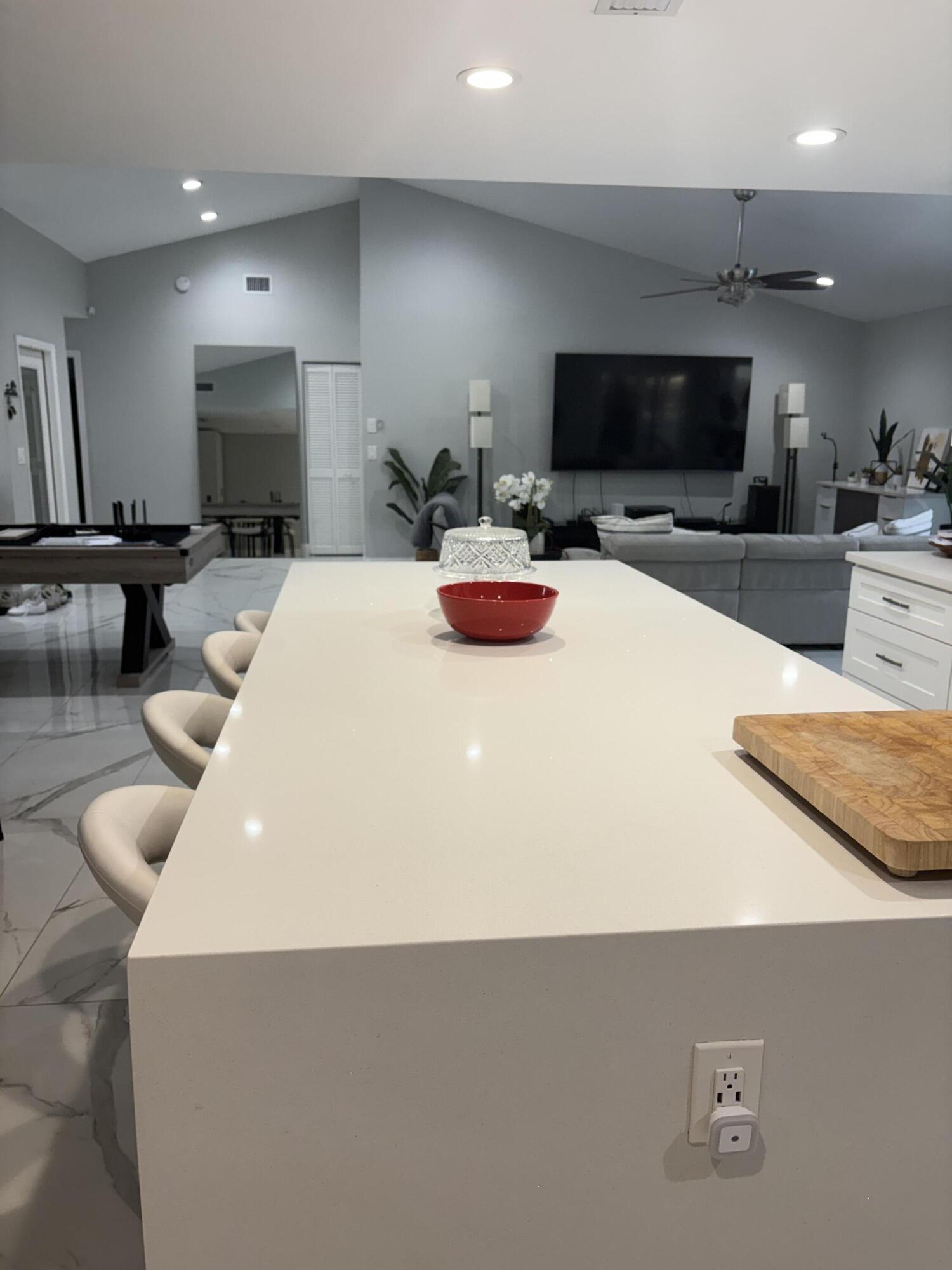 18255 181st Circle South Boca Raton, FL 33498 - Photo 7 of 15 a kitchen with a microwave a stove and white cabinets
