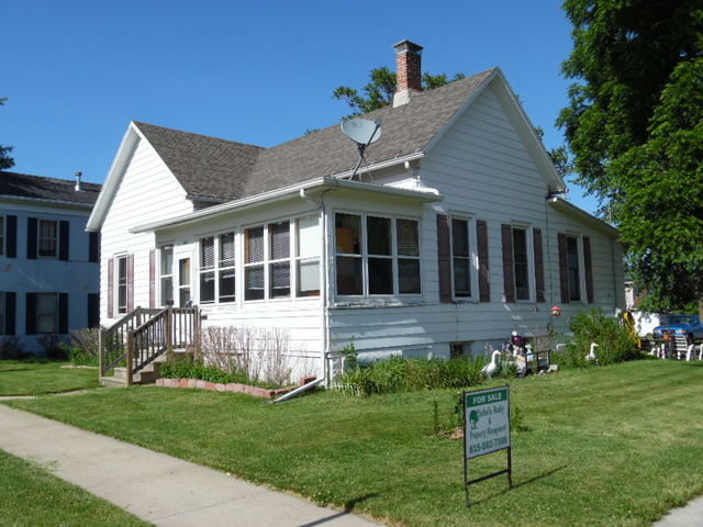 401 North 3rd Street Rochelle, IL 61068 - Photo 2 of 5 a front view of a house with a yard table and chairs