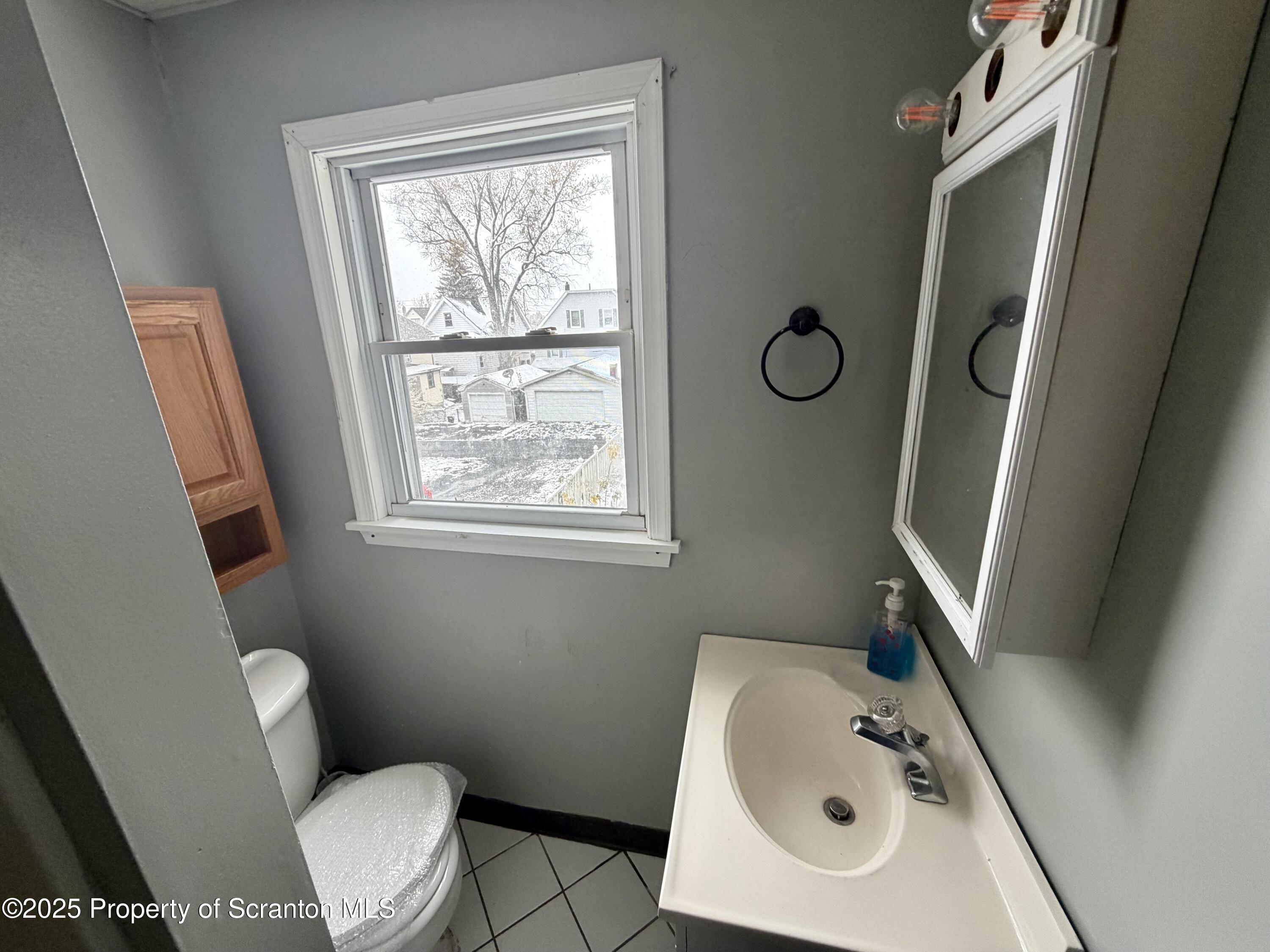 818 West Locust Street Scranton, PA 18504 - Photo 15 of 15 a bathroom with a toilet sink and mirror