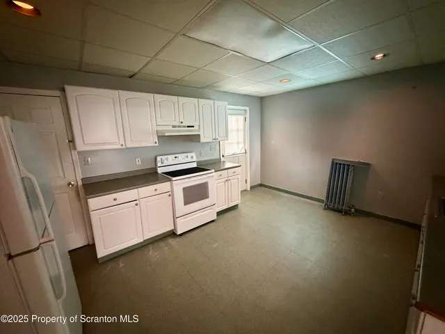 a kitchen with stainless steel appliances a stove a sink and a refrigerator