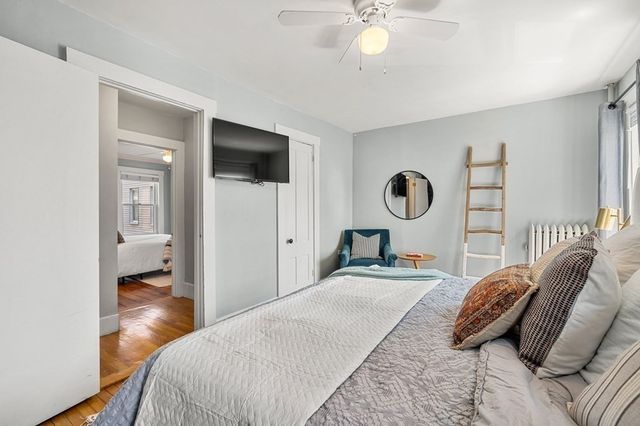 a bedroom with a bed and a chandelier