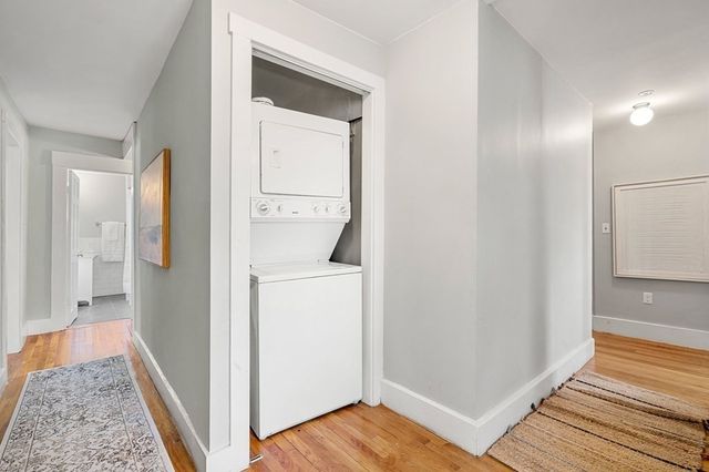 a view of hallway with wooden floor