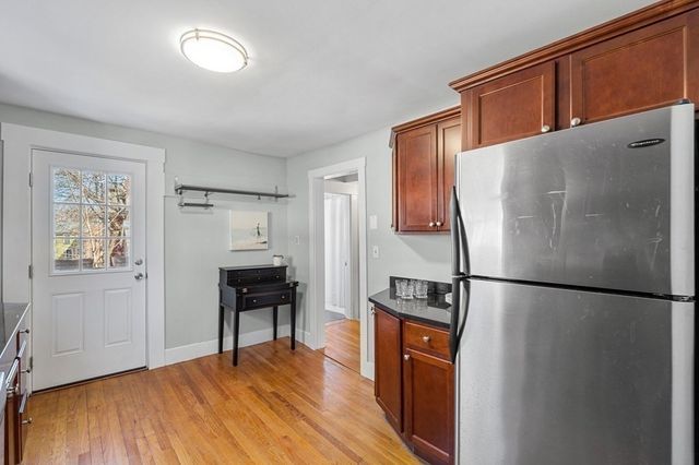 a kitchen with stainless steel appliances a refrigerator and a stove top oven