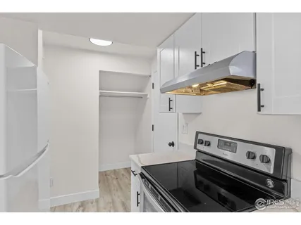 a kitchen with stainless steel appliances granite countertop a stove and a refrigerator