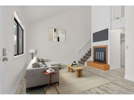 a living room with furniture a window and a potted plant