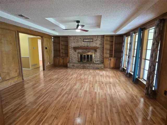 wooden floor in an empty room with a fireplace