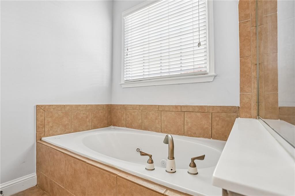810 Freedom Way Cumming, GA 30040 - Photo 23 of 61 a bathroom with a tub and a window