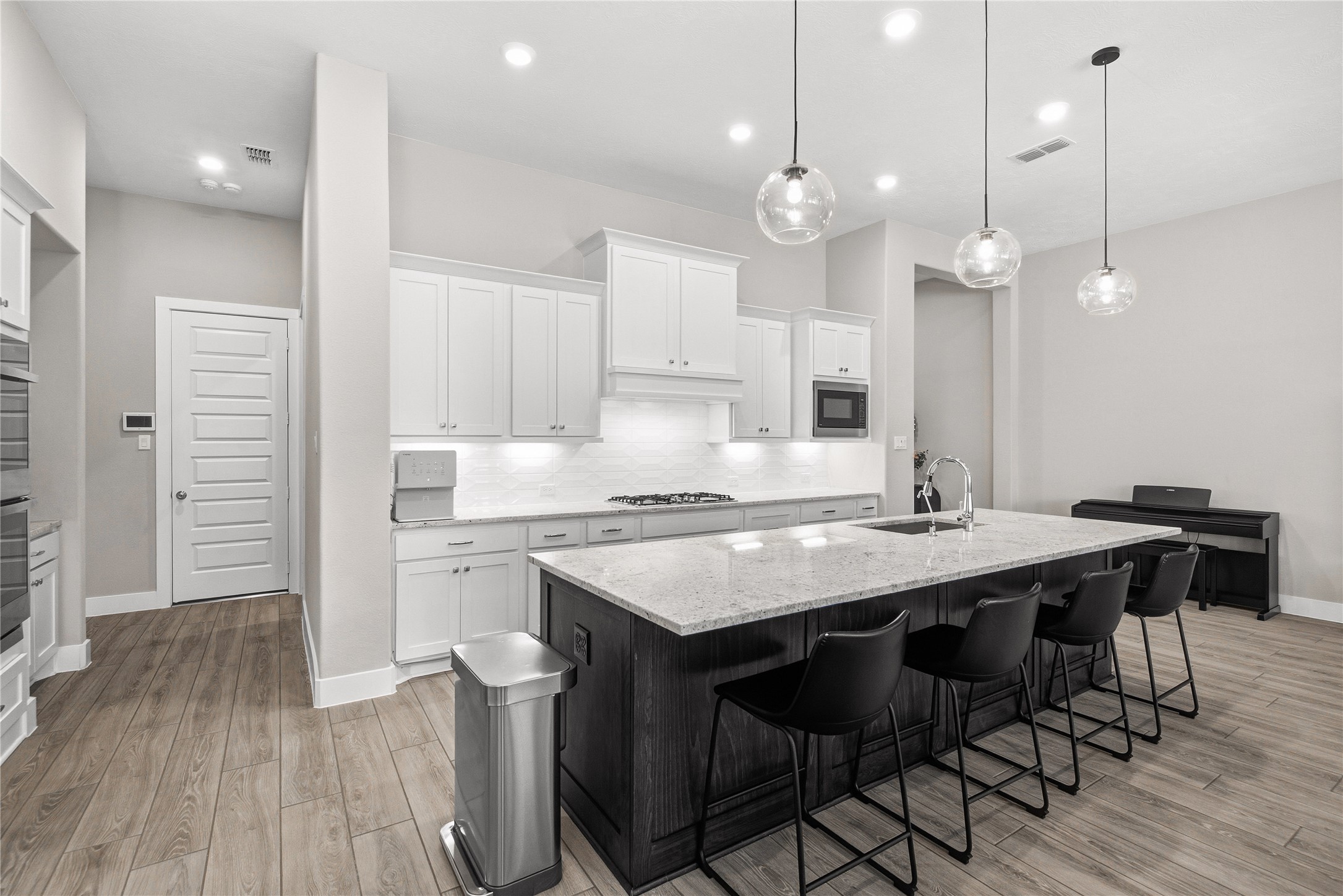 1222 McMurtry Ridge Drive Katy, TX 77494 - Photo 17 of 49 a kitchen with a dining table chairs sink and cabinets