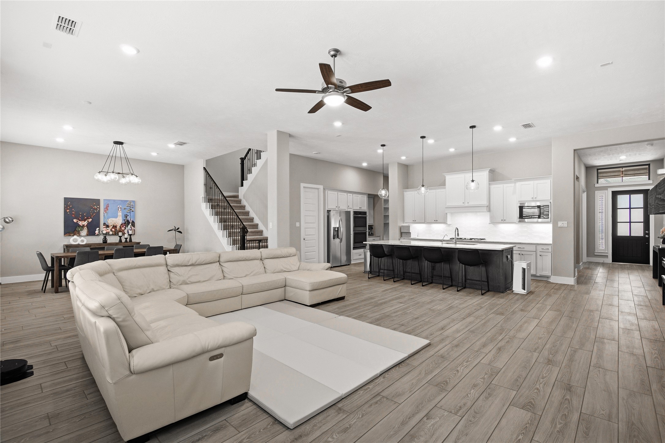 1222 McMurtry Ridge Drive Katy, TX 77494 - Photo 21 of 49 a living room with furniture kitchen view and a wooden floor