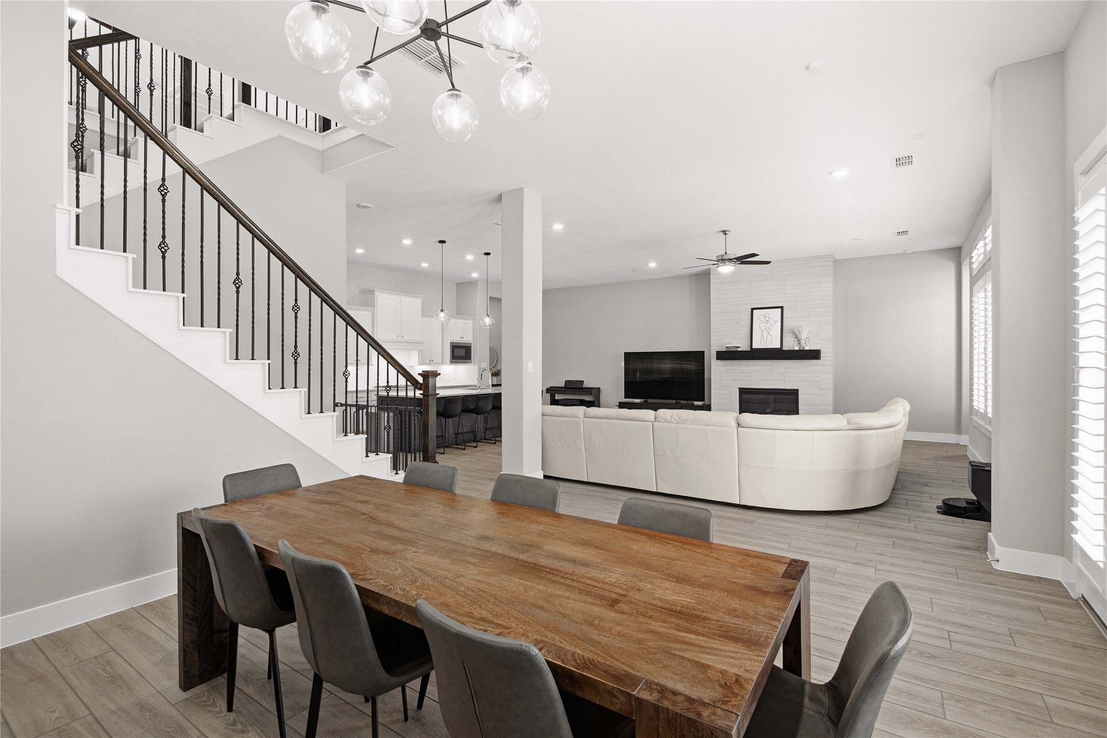 1222 McMurtry Ridge Drive Katy, TX 77494 - Photo 23 of 49 a dining room with wooden floor a chandelier a wooden table and chairs