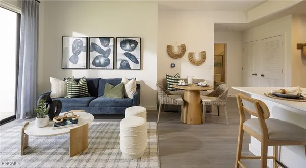 a living room with furniture and painting on the wall
