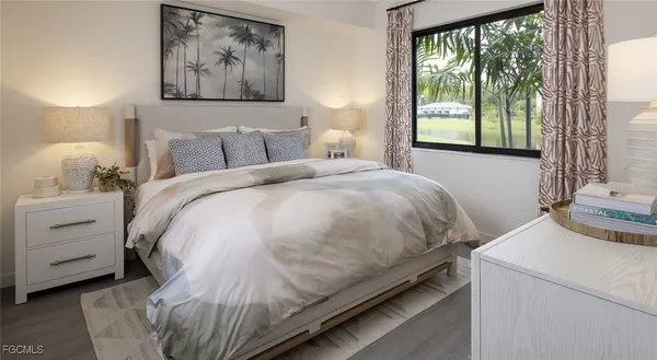 a bed sitting in a bedroom next to a window
