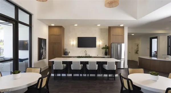 a view of a dining room with furniture a livingroom and chandelier