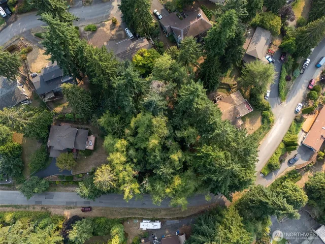 an aerial view of a house with garden space and street view