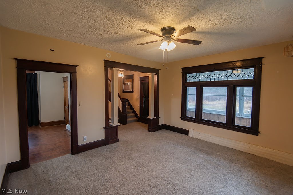 1195 South Johnson Road Sebring, OH 44672 - Photo 11 of 34 Unfurnished bedroom featuring carpet floors, a textured ceiling, and a ceiling fan