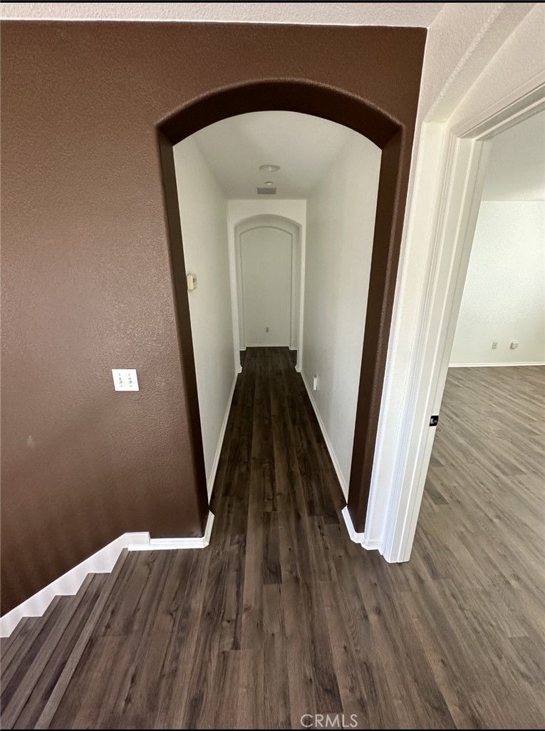 11306 Trailstone Court Riverside, CA 92505 - Photo 16 of 47 a view of a hallway with wooden floor and staircase