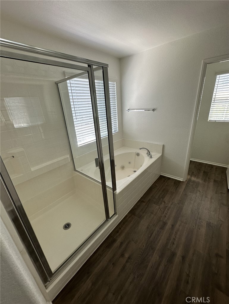 11306 Trailstone Court Riverside, CA 92505 - Photo 19 of 47 a bathroom with a tub and shower