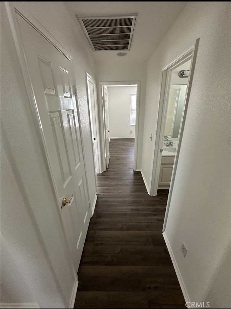 11306 Trailstone Court Riverside, CA 92505 - Photo 21 of 47 a view of a hallway with wooden floor and staircase