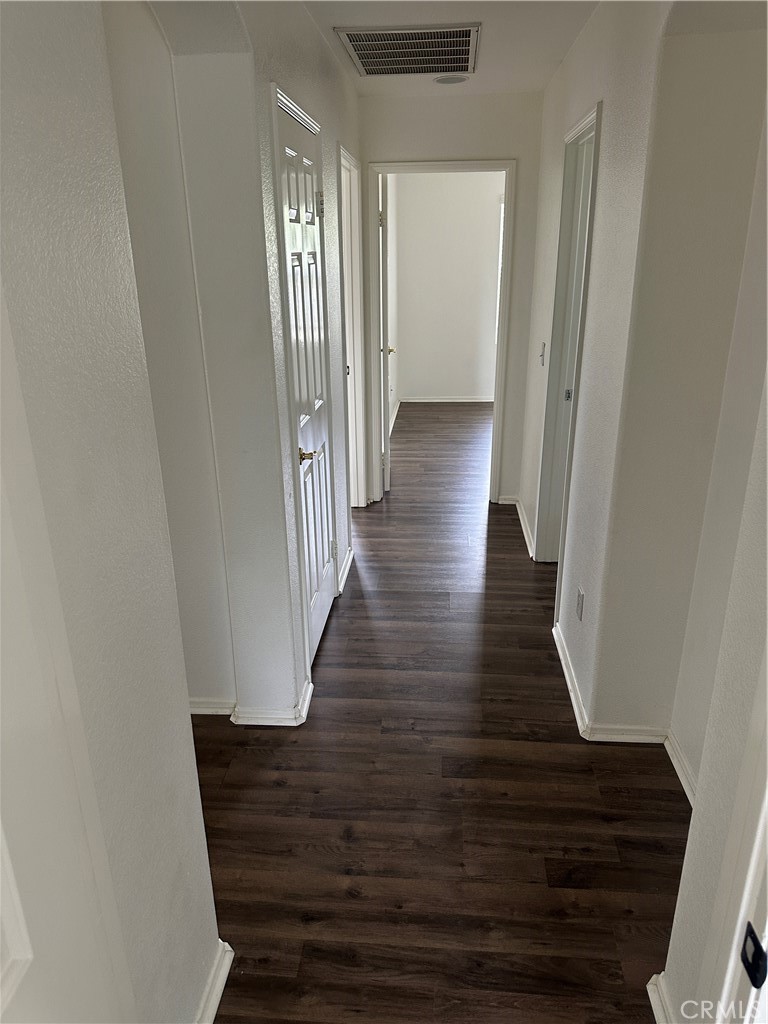 11306 Trailstone Court Riverside, CA 92505 - Photo 31 of 47 a view of a hallway with wooden floor and entryway
