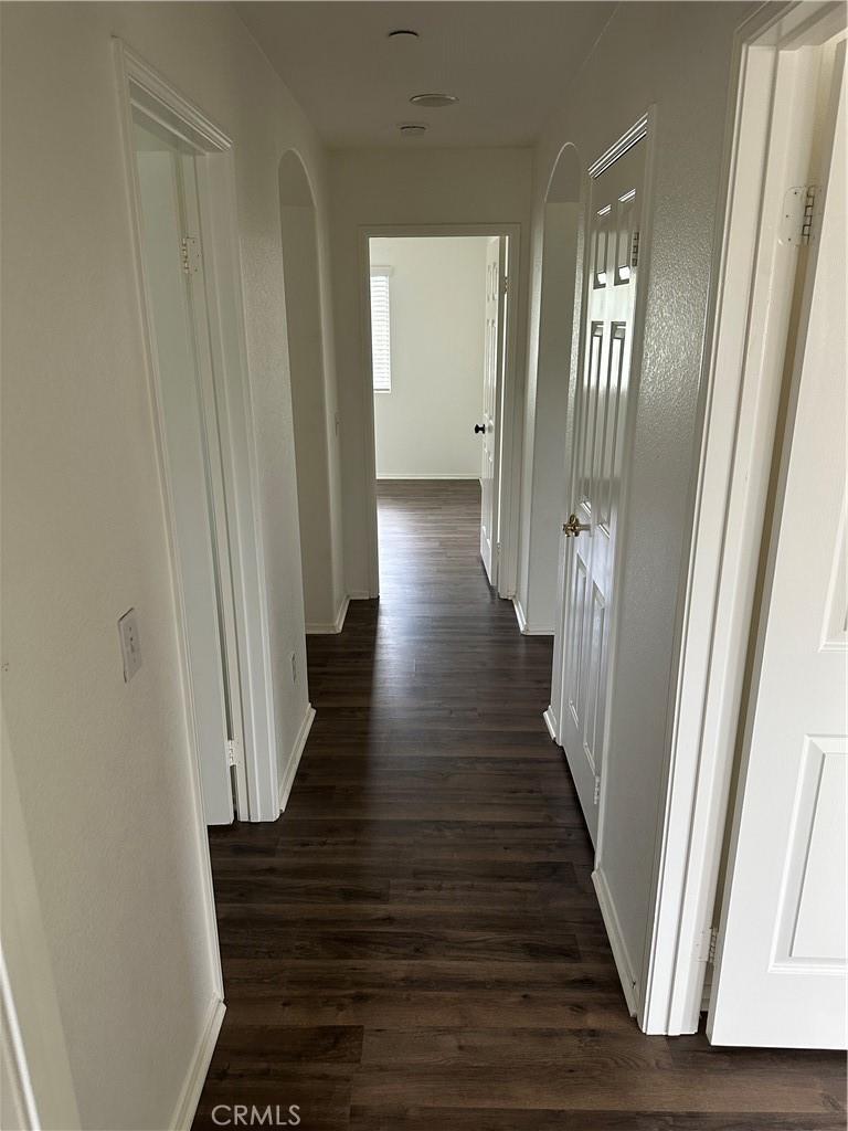 11306 Trailstone Court Riverside, CA 92505 - Photo 33 of 47 a view of a hallway with wooden floor and staircase