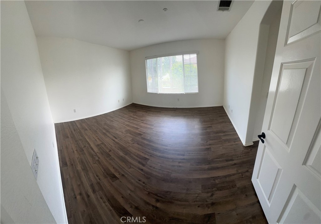 11306 Trailstone Court Riverside, CA 92505 - Photo 40 of 47 an empty room with wooden floor and windows