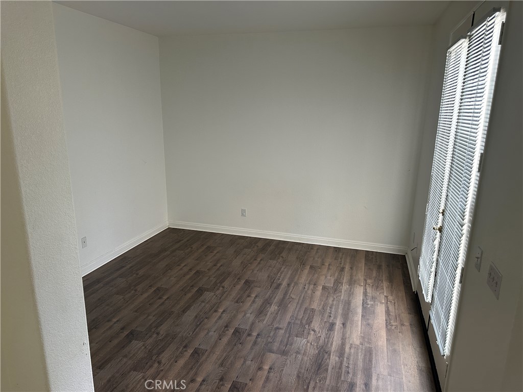 11306 Trailstone Court Riverside, CA 92505 - Photo 41 of 47 a view of an empty room with wooden floor and a window