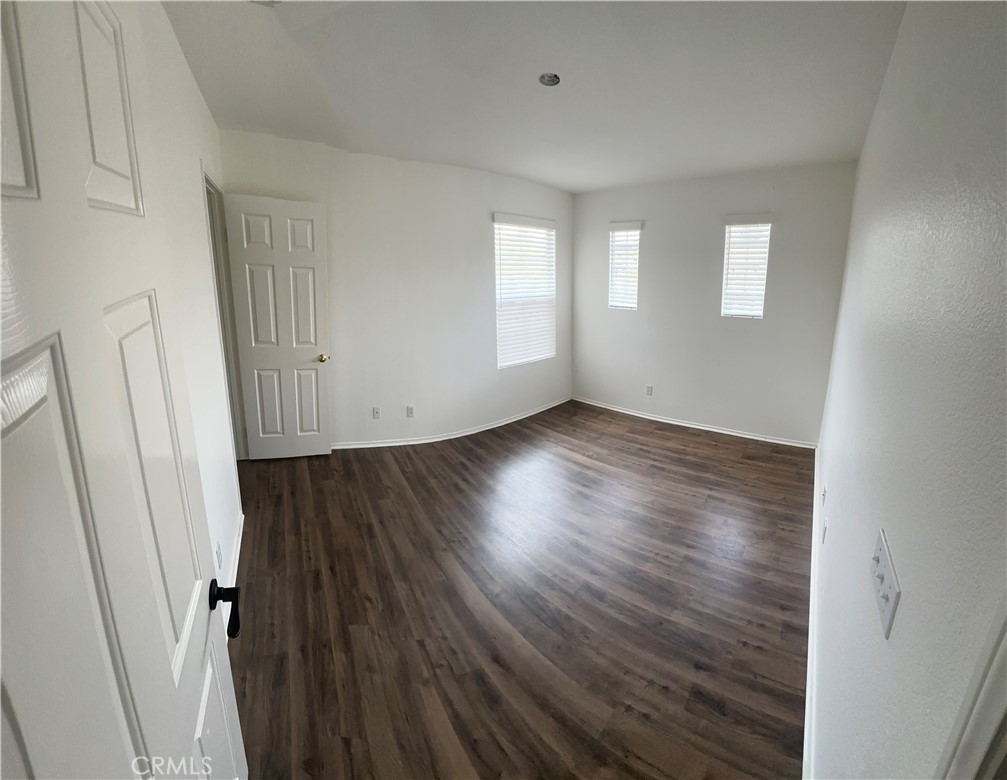11306 Trailstone Court Riverside, CA 92505 - Photo 45 of 47 an empty room with wooden floor and windows