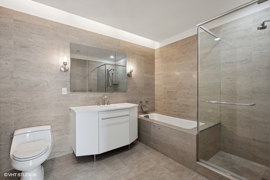 401 North Wabash Avenue, Unit 42E Chicago, IL 60611 - Photo 15 of 55 a bathroom with a granite countertop sink toilet and shower