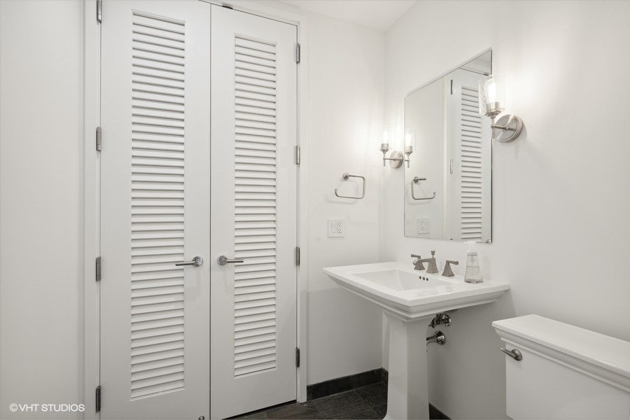 401 North Wabash Avenue, Unit 42E Chicago, IL 60611 - Photo 16 of 55 a bathroom with a sink and a mirror