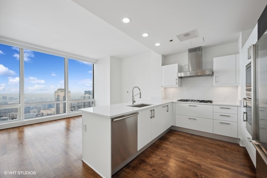 401 North Wabash Avenue, Unit 42E Chicago, IL 60611 - Photo 2 of 55 a kitchen with a sink stainless steel appliances and cabinets